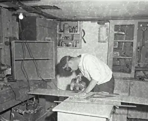 Carpentry Prints: Vintage Photograph. A man cutting a piece of plywood. Frame 2