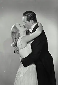 Kissing Prints: Vintage photograph. Man kissing and hugging woman