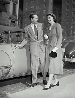 Shirt And Tie Prints: Vintage photograph. Man opening car door for his date
