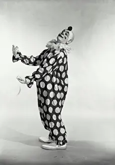 Arts Culture And Entertainment Prints: Vintage Photograph. Man in polka dot clown suit turned to side