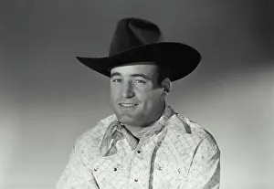 Ives Prints: Vintage Photograph. Man sits for studio portrait smiling in black cowboy hat and bandana
