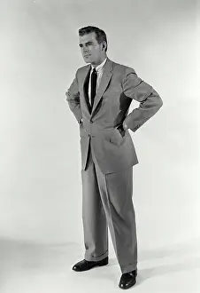 Business Attire Prints: Vintage Photograph. A man standing with hands on his hips with a stern expression