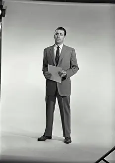 Shirt And Tie Prints: Vintage Photograph. Man in suit and tie holding sheet of paper on white background