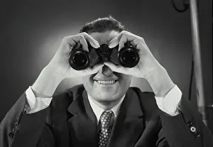 Curiosity Prints: Vintage Photograph. Man in suit and tie looking through binoculars. Frame 1
