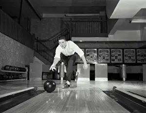 Lane Prints: Vintage photograph. Man throwing bowling ball down lane