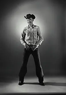 Boots Prints: Vintage Photograph. Man in western wear with hands on belt buckle. Frame 2