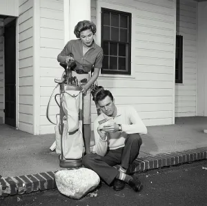 Fresh Vintage Prints: Vintage Photograph. Man and wife on front porch with golf bag. Frame 15
