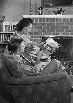 Models Prints: Vintage Photograph. Man and Wife sitting in chair and looking at picture. Frame 4