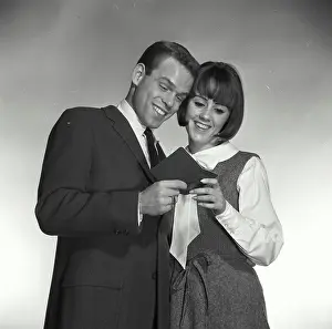 Grayscale Prints: Vintage Photograph. A man and woman looking at bank book smiling