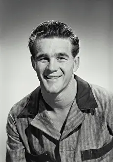 Work Clothes Prints: Vintage photograph. man in work clothes smiling at camera