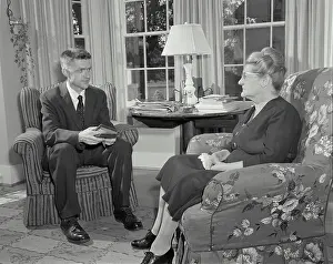 Dialogue Prints: Vintage Photograph. Minister talking to woman in her home. Frame 1