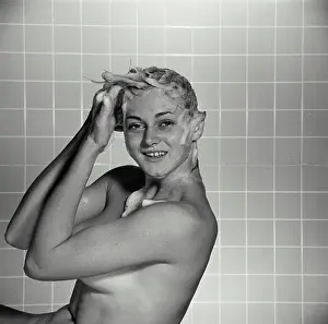 Soap Prints: Vintage Photograph. Nude woman shampooing hair in front of tile wall, Frame 4