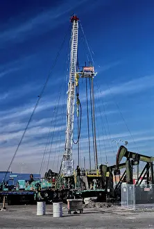Infrastructure Prints: Vintage Photograph. Oil drilling rig under a clear blue sky