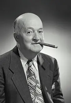 Bald Prints: Vintage photograph. Older bald man in suit and tie smoking cigar
