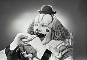 Face Paint Prints: Vintage photograph. Portrait of clown wearing silly hat with hand sandwiched between two pieces of bread