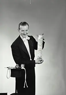 Mystery Prints: Vintage Photograph. Portrait of a magician performing card tricks