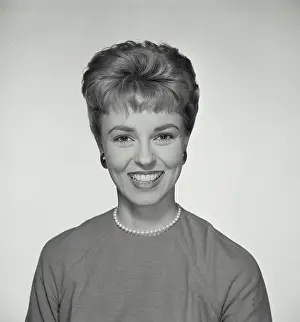 Sweater Prints: Vintage Photograph. A portrait of a woman with a big smile wearing a pearl necklace with short hairstyle