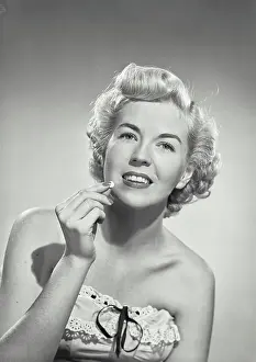 Pill Prints: Vintage photograph. portrait of woman in strapless dress smiling at camera holding pill