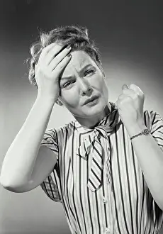 Suffering Prints: Vintage photograph. Portrait of woman in striped blouse with hand on forehead in pain