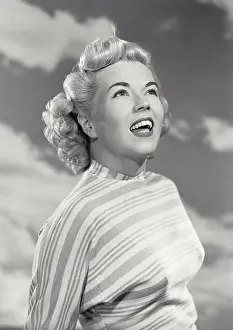 Vintage photograph. Portrait of woman in striped blouse smiling off camera