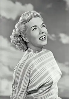 Medium Length Hair Prints: Vintage photograph. Portrait of woman in striped blouse smiling off camera
