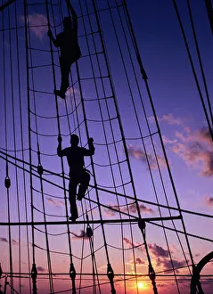 Marine Prints: Vintage Photograph. Sailors climb the rigging of a ship at sunset