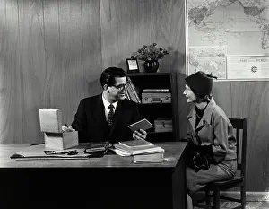 Conversation Prints: Vintage Photograph. School counselor discussing pupil's record with mother