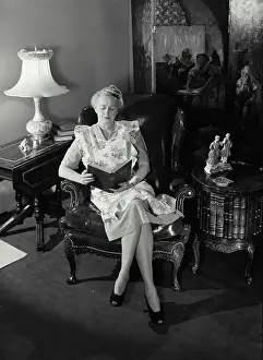 Leather Prints: Vintage Photograph. Senior woman sitting in chair reading the Holy Bible