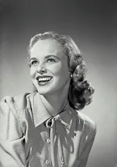 Medium Length Hair Prints: Vintage Photograph. Smiling blonde woman wearing button up blouse with knot tied on collar