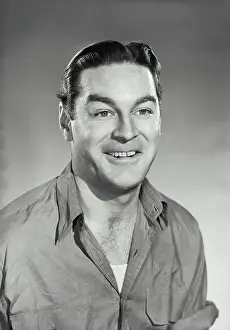 Wrinkled Prints: Vintage photograph. Smiling brunette man wearing wrinkled work shirt