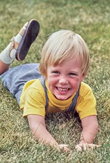 Overalls Prints: Vintage Photograph. Smiling child enjoying a sunny day on the grass