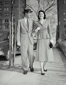Shirt And Tie Prints: Vintage photograph. Smiling man and woman walking on city sidewalk