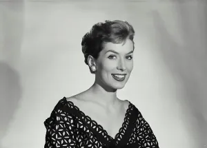 Vintage Photograph. Smiling woman with short hair wearing black lace blouse