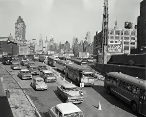 Streets Prints: Vintage Photograph. Streets with busy traffic leading into Lincoln Tunnel looking back at skyline of New York City