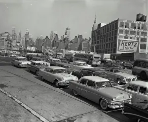 Cars Prints: Vintage Photograph. Streets with busy traffic leading into Lincoln Tunnel looking back at skyline of New York City