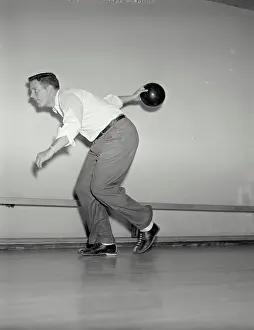Lane Prints: Vintage photograph. Side view of man throwing bowling ball down lane