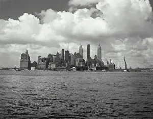 Manhattan Prints: Vintage photograph. view of Manhattan skyline with clouds behind