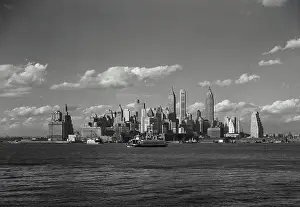 Passing Prints: Vintage Photograph. View of New York City Skyline from across the East River with ferries passing