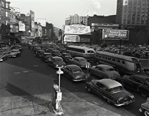 Buildings Prints: Vintage Photograph. Vintage city traffic scene showcasing classic cars and urban hustle