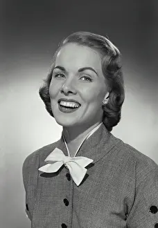 Joan Prints: Vintage photograph. Woman in button blouse with bow smiling at camera
