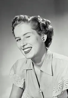 Lipstick Prints: Vintage photograph. Woman in collared blouse winking at camera