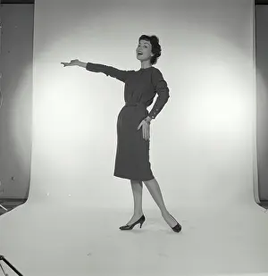 Presenting Prints: Vintage Photograph. Woman laughing while her hand is out presenting