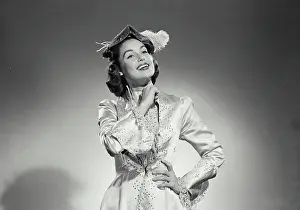 Gown Prints: Vintage Photograph. Woman in long gown and feathered hat on white background. Frame 5