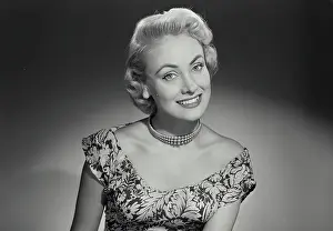 Vintage Photograph. Woman in lowcut dress smiling at camera