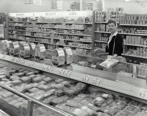Purchase Prints: Vintage Photograph. Woman shopping at smiling at Supermarket