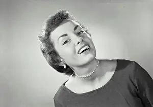 Vintage photograph. Woman with short hair wearing pearl necklace and blouse