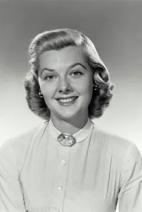 Jewel Prints: Vintage Photograph. Woman sits smiling for studio portrait with a white shirt on with a jewel at the top