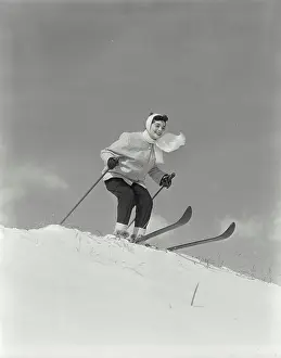 Pole Prints: Vintage Photograph. Woman on skis at top of hill