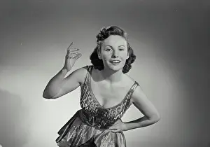 Sparkle Prints: Vintage Photograph. Woman in sparkle dress smiling with hand up