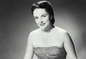 Cinematic Prints: Vintage Photograph. Woman in strapless dress and chain necklace with pleasant smile